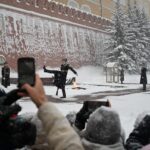 Emberek fotózzák a díszörséget Moszkvában a Vörös téren.