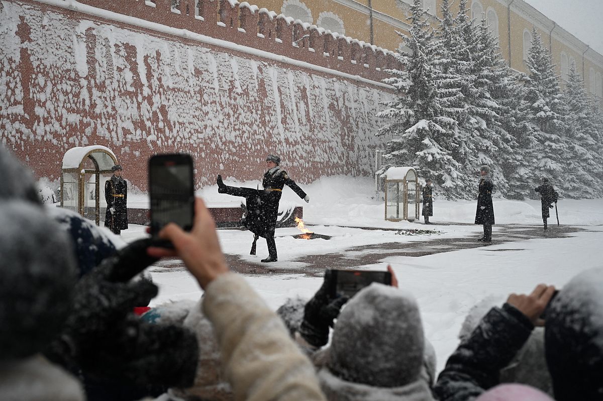 Emberek fotózzák a díszörséget Moszkvában a Vörös téren.
